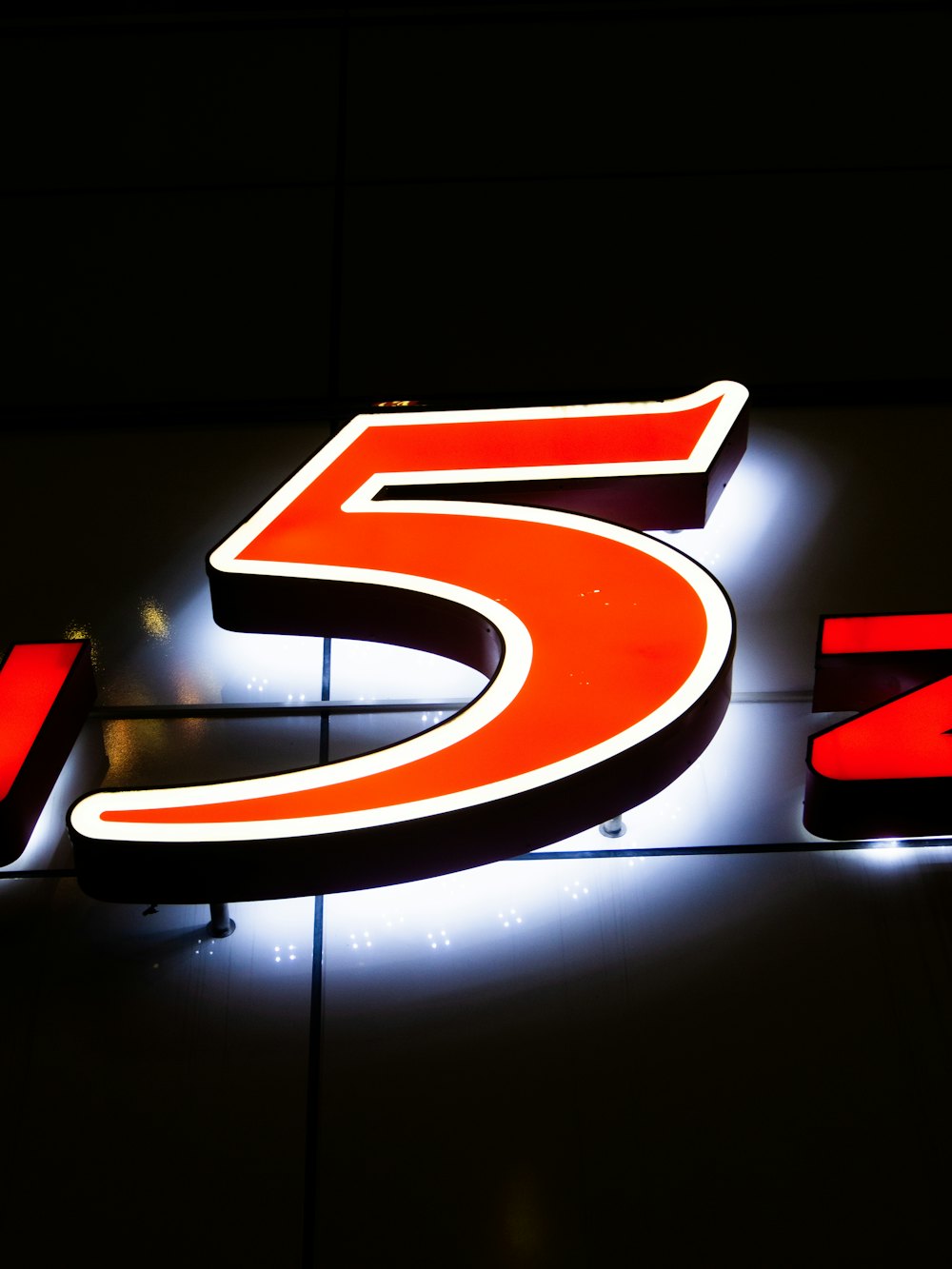 Illuminated red channel letters at night