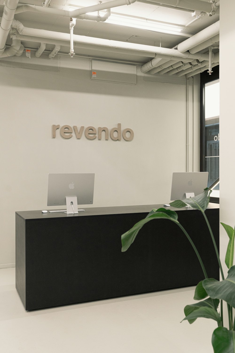 Lobby reception desk with a logo sign on the wall
